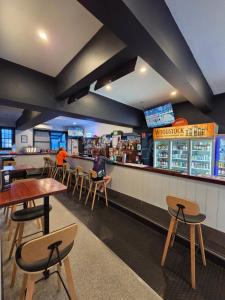a restaurant with tables and chairs and a bar at The Rec Hotel Waroona in Waroona