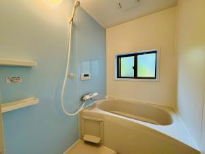 a bath tub in a bathroom with a window at 風乃釣り宿 in Shirahama +17 photos