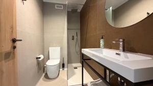 a bathroom with a sink and a toilet and a mirror at HS Olivos in Alcalá del Júcar