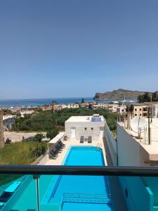 a view of a swimming pool from the balcony of a house at Aestas Apartments in Agia Marina Nea Kydonias