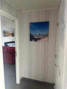 a door to a room with a picture on the wall at de Zeester in Bredene-aan-Zee