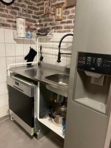 a small kitchen with a sink and a stove at The Rusty Corner in Solingen +9 photos