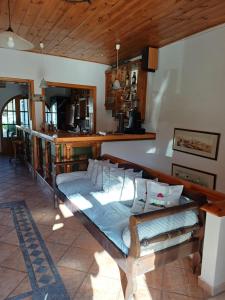 a wooden bed in a room with a kitchen at Siroco's Rooms And Studios in Parikia