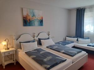 two twin beds in a room with at Hotel Hirsch in Sinsheim