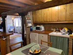 a kitchen with a table and a counter top at Ermita de la Tuda-Villaescusa de las Torres in Villaescusa de las Torres