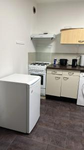 a kitchen with a stove and a white refrigerator at Escale Rennes in Rennes +10 photos