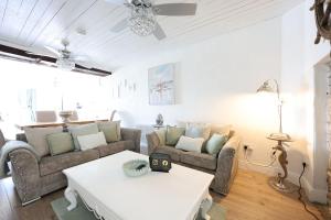 a living room with two couches and a table at Holland House No2 in Liscannor +15 photos