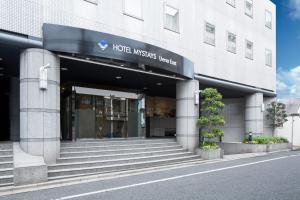 una entrada del hotel con escaleras que conducen a un edificio en HOTEL MYSTAYS Ueno East en Tokio