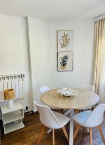 a dining room with a table and white chairs at Puerto de Pollença - Beach and Center,Happy Mar in Port de Pollensa