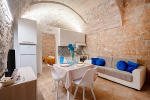 a living room with a couch and a table with blue pillows at Il Corallo in Molfetta