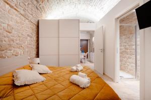 a bedroom with a large orange bed with white pillows at Il Corallo in Molfetta