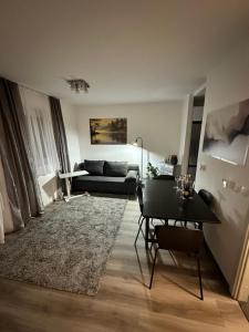 a living room with a couch and a table at Hiška Orel Terme Čatež in Čatež ob Savi