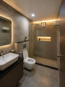 a bathroom with a toilet and a sink and a shower at Hotel Royal Blue in Modāsa