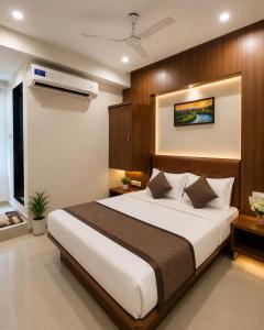 a bedroom with a large bed in a room at Hotel Royal Blue in Modāsa +5 photos