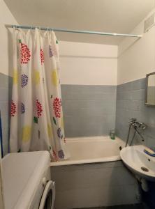 a bathroom with a tub and a sink and a shower curtain at Apartment on Y. Mudroho 44 in Bila Tserkva
