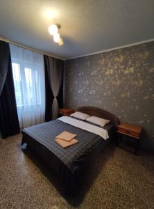 a bedroom with a bed with two towels on it at Apartment on Y. Mudroho 44 in Bila Tserkva