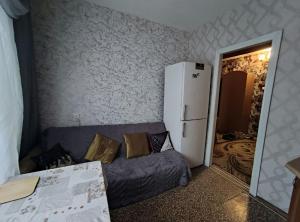 a kitchen with a couch and a refrigerator in a room at Apartment on Y. Mudroho 44 in Bila Tserkva