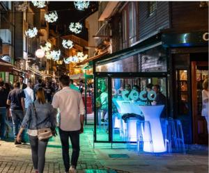 a group of people walking down a street at night at Bruma in Vilagarcia de Arousa