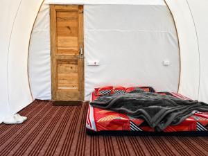 a bed in a tent with an open door at Vintage Vista Camps in Kasol