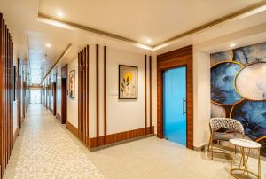 a corridor in a hotel with paintings on the walls at Hotel Chand Ratan Palace By Travinities in Bikaner +50 photos