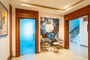 a lobby with a glass door and two chairs at Hotel Chand Ratan Palace By Travinities in Bikaner