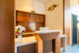 a waiting room with a vase of flowers on a desk at Hotel Chand Ratan Palace By Travinities in Bikaner