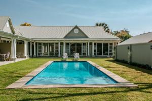 a house with a swimming pool in the yard at Highlands House in Harare