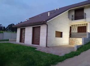 a house with two garage doors and a yard at Andreamar in Cambados
