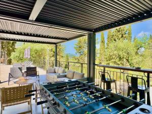 a patio with a large ping pong table at Domenico Morani Luxury Villa Concept with private pool by DadoVillas in Gastouri