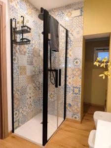 a glass shower in a bathroom with a tile wall at "Il Vecchio Salone" appartamento in pieno centro con garage privato in Lecce +45 photos