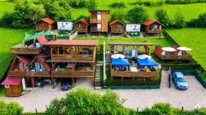 an aerial view of a house with cars parked in front at Bosnian Pyramid Glamping in Visoko