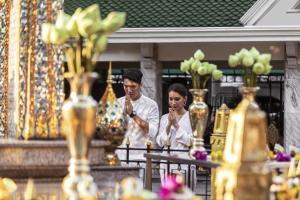 a man and woman standing in a store with vases at Courtyard by Marriott Bangkok in Bangkok