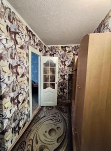 a hallway with a door in a room with a wallpaper at Apartment on Y. Mudroho 44 in Bila Tserkva +1 photo