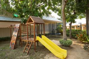 a playground with a slide and a play structure at Rocco Hotel Bangsaen in Ban Laem Thaen