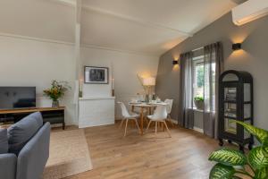 a living room with a couch and a table at Het Herenhuis Middelburg in Middelburg