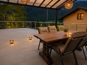 a wooden table and chairs on a patio at Nortra apartment in Tolmin