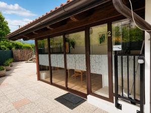 a patio with glass doors on a house at Nortra apartment in Tolmin