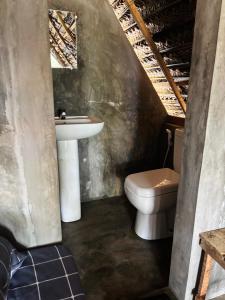 a bathroom with a sink and a toilet at Wana beach camp in Raddela
