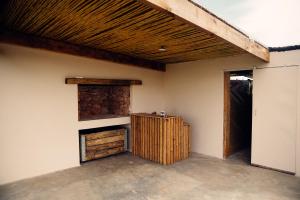 a room with a fireplace and a wooden ceiling at Nama-Qua Game Reserve in Vredendal