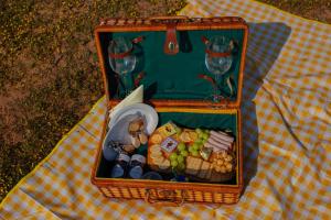a picnic basket with food and wine glasses on a table at Nama-Qua Game Reserve in Vredendal