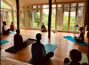 a group of people sitting on the floor in a yoga class at Cabane étape in Idrac-Respailles