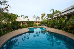 a swimming pool in the middle of a resort at Rocco Hotel Bangsaen in Ban Laem Thaen