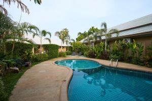 a swimming pool in the yard of a house at Rocco Hotel Bangsaen in Ban Laem Thaen +43 photos