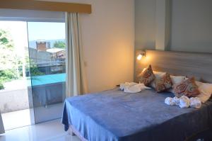 Ένα ή περισσότερα κρεβάτια σε δωμάτιο στο Hotel Puesta del Sol by Nobile
