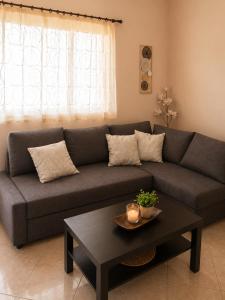 a living room with a couch and a coffee table at Analipsis Messinis Apartments in Análipsis