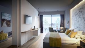a hotel room with a king sized bed and a living room at MY HOTEL MALMEDY in Malmedy +32 photos