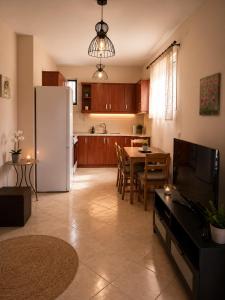 a kitchen with a white refrigerator and a table at Analipsis Messinis Apartments in Análipsis
