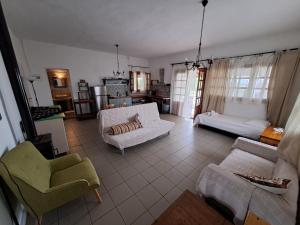 a living room with two white couches and chairs at Lofos Vourvourou in Vourvourou +67 photos