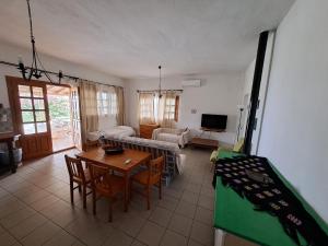 a living room with a table and a couch at Lofos Vourvourou in Vourvourou