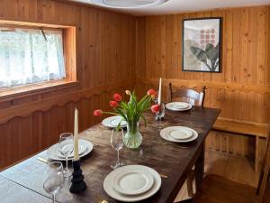 a wooden table with plates and flowers on it at Willa Wielka Puszcza in Porąbka +34 photos